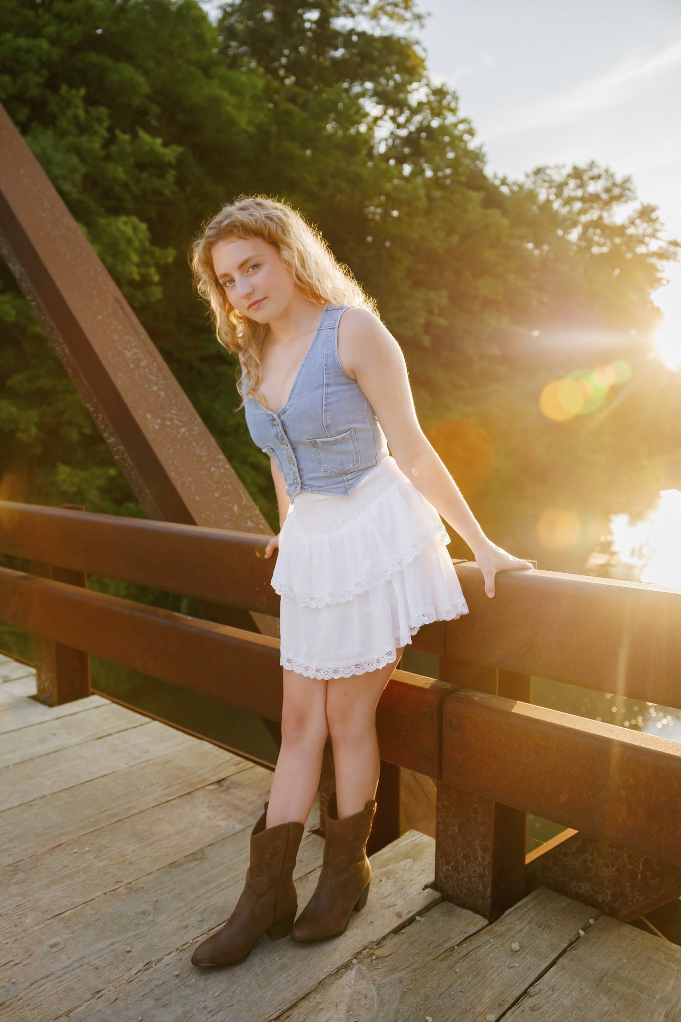 Teagan on a rusted truss bridge at golden hour